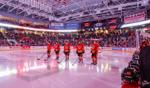 University of Guelph hockey players standing on the ice during the Frosty Mug event, with a packed arena of cheering fans in the background.