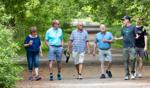 University of Guelph alumni participating in an Arboretum walk during a workshop event on a tree-lined path.