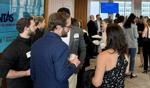 LANG graduates mingling at a networking event.