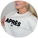 A woman wearing a white sweatshirt with bold black embroidered text reading "APRÈS SKI," smiling and holding the edge of her sweater.