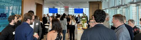 LANG graduates mingling at a networking event.