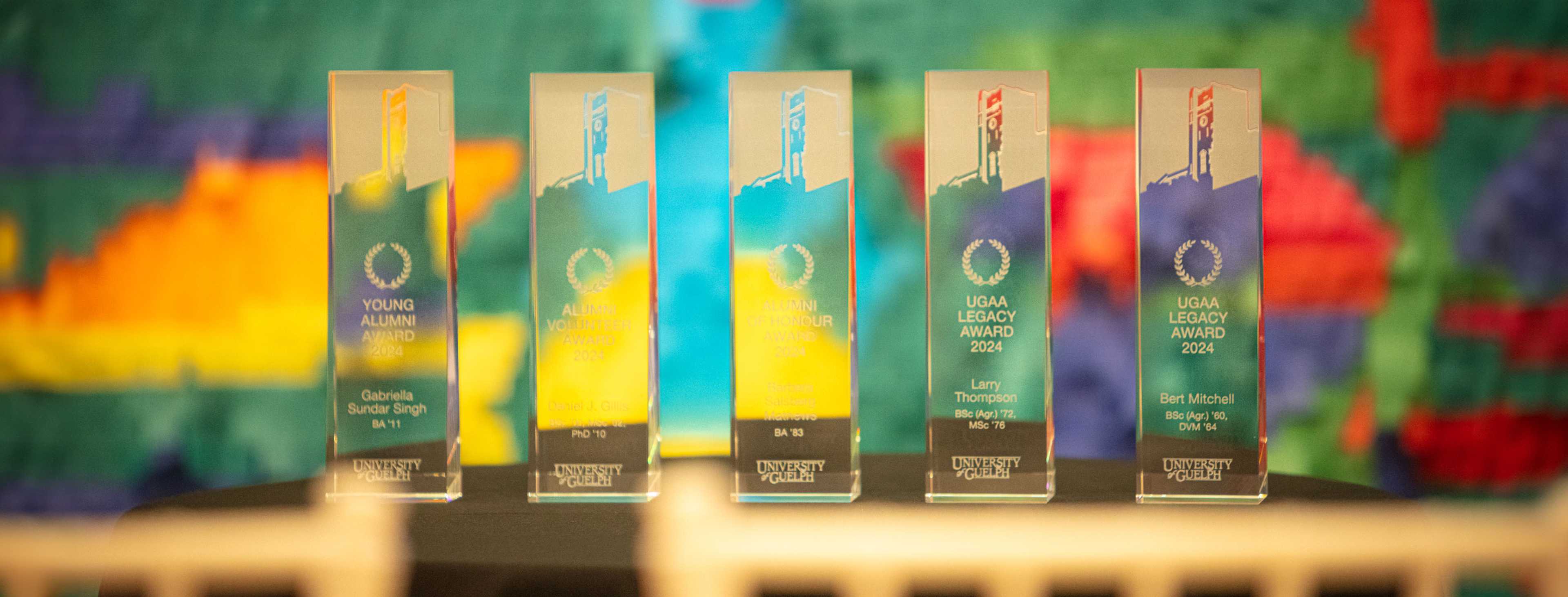 University of Guelph Alumni Awards of Excellence trophies against a colorful backdrop.