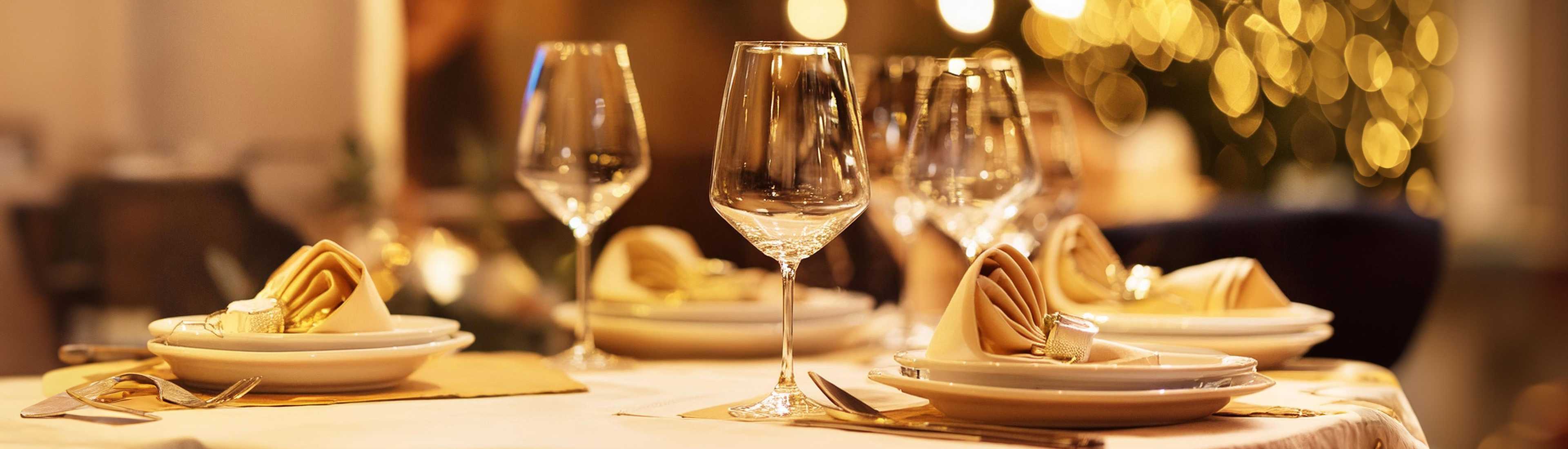 Elegant table setting with wine glasses and folded napkins at the OAC Goodtimes Banquet, Ancaster Fairgrounds. 